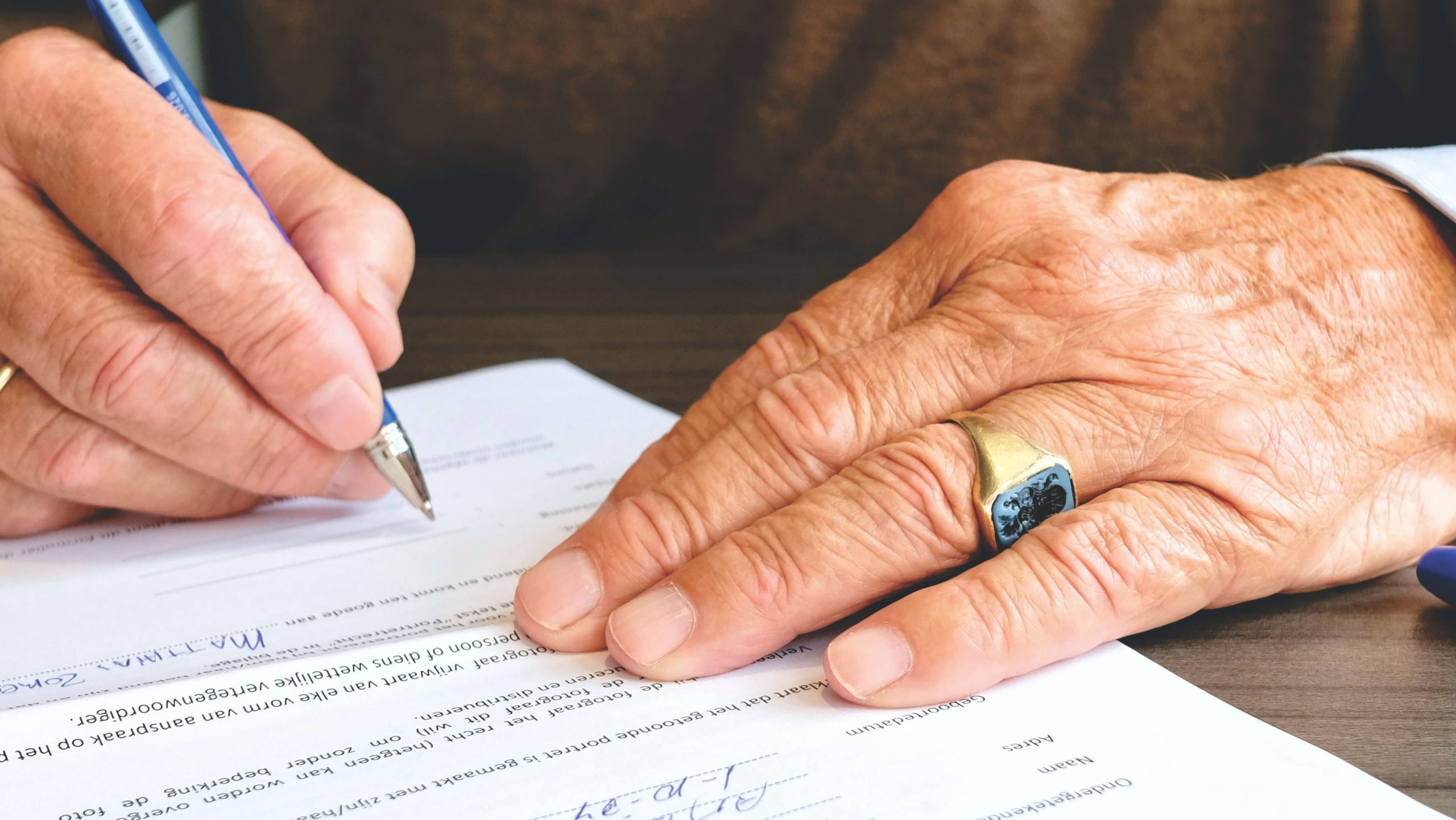 Elder Individual Signing a Document