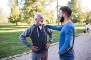 younger man talking with his dad while out on a run