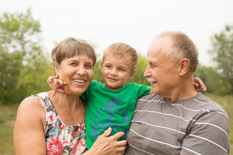 grandparents smiling with grandson