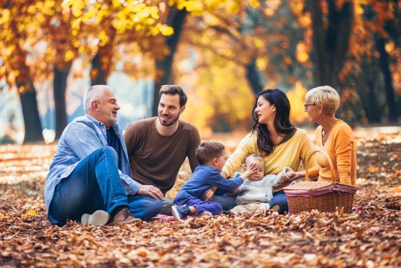 happy smiling family sitting together outside