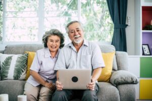 older couple in living room working on retirement