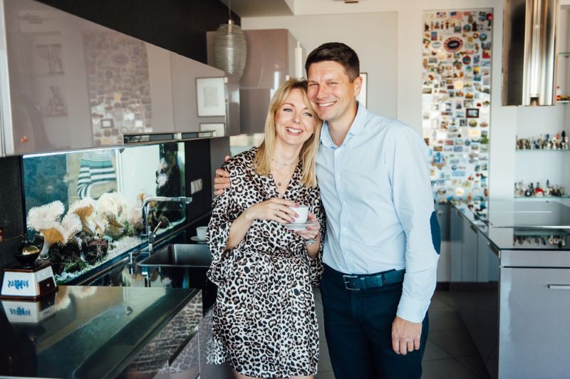 happy and smiling couple standing together in the kitchen