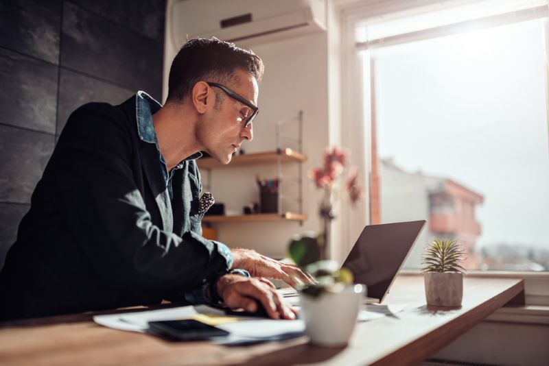 man reviewing paperwork and documents at home