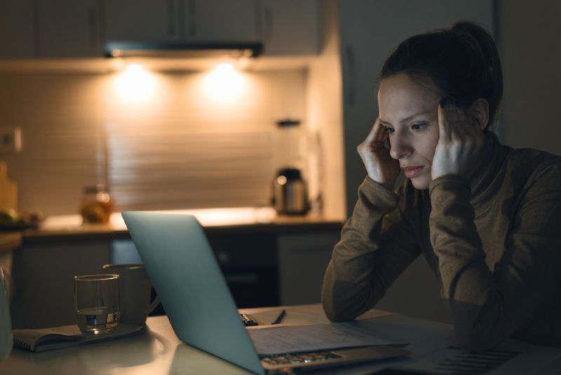 stressed woman at home on her laptop